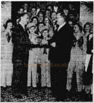 Leslie Holderness, Manager of the Birmingham Paramount Theatre, receiving a Clock and Crocodile Wallet from the Technical Staff and Secretary of the Theatre on the occasion of the Theatre's first anniversary in 1938 - From the Evening Dispatch, 5th of September 1938.