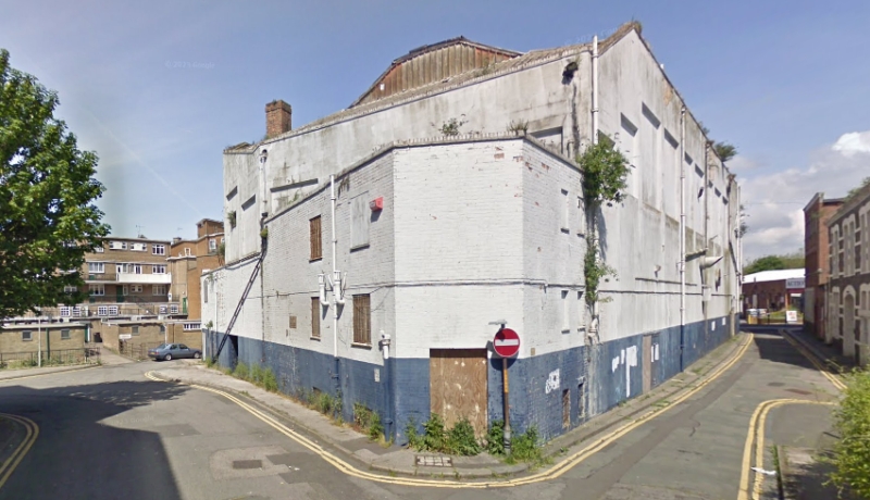 A Google StreetView Image showing the rear and side elevations of the former Granada Theatre, Dover, closed and boarded up in June 2009 - Click to Interact.