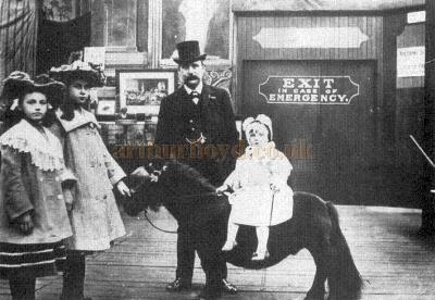 E. H. Bostock in the Zoo Buildings, Glasgow, in 1903 with his three daughters.