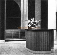 Fluted mahogany front to the reception counter and horizontal oak louvre as a radiator casing.