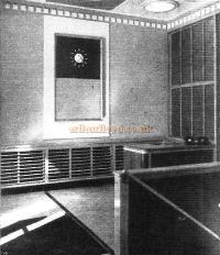 Aldwych side entrance showing dado panelling of Indian laurel with oak framing, and recessed clock with Indian laurel backing.