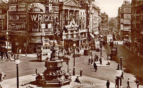 The London Pavilion covered in advertising signs which is how it remained until the building's exterior was restored in 1986.