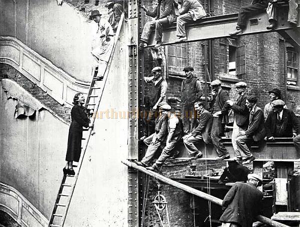 After laying the foundation stone of the new Prince Of Wales Theatre in London in June 1937, Gracie Fields sings to the workmen. (Note that part of the old theatre auditorium is still visible in this picture) - From the archives of the Radio Times Hulton Picture Library